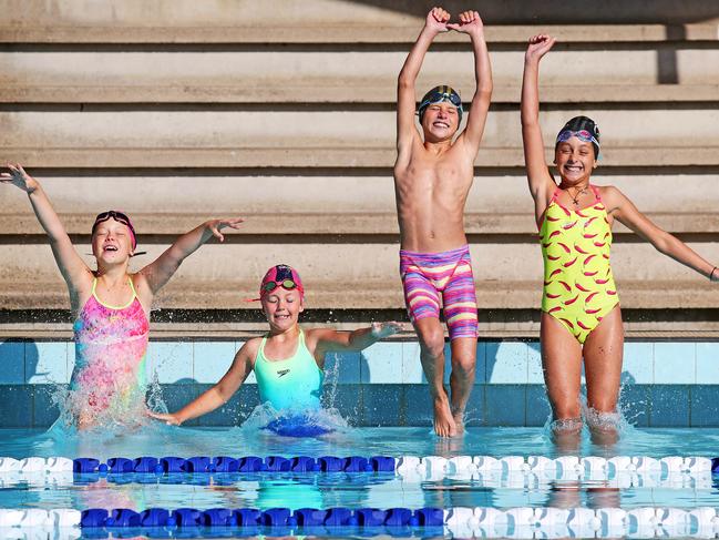 School-aged swimmers Ella Hradecky 8, Sarah Richards 8, and twins Leigh and Victoria Syrakis 11, are elated to jump back in the pool. Picture: Tim Hunter