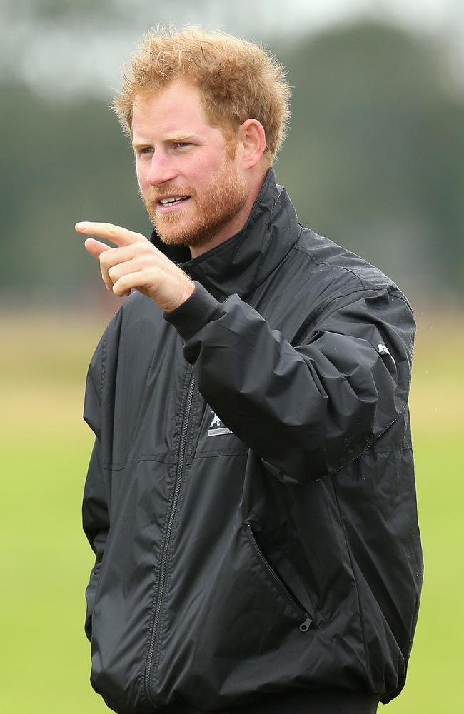 Prince Harry walks on the airfield at Goodwood Aerodrome as he is shown Spitfire Aircraft that will take place in a Battle of Britain Flypast at Goodwood in Chichester, England. Picture: Getty