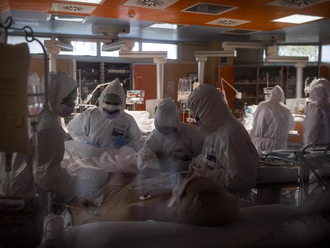 Doctors treat COVID-19 patients in an intensive care unit in Rome, Italy.