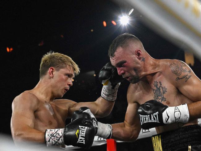 Nikita Tszyu (L) fights against his compatriot Bo Belbin during their super welterweight bout. (Photo by Saeed KHAN / AFP)