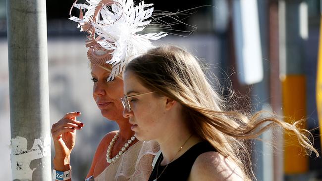 Racegoers leave Royal Randwick racecourse after the Melbourne Cup race meet. Shari Lea Hitchcock (L), former mistress to the late Richard Pratt crosses Alison Rd. Picture: Toby Zerna