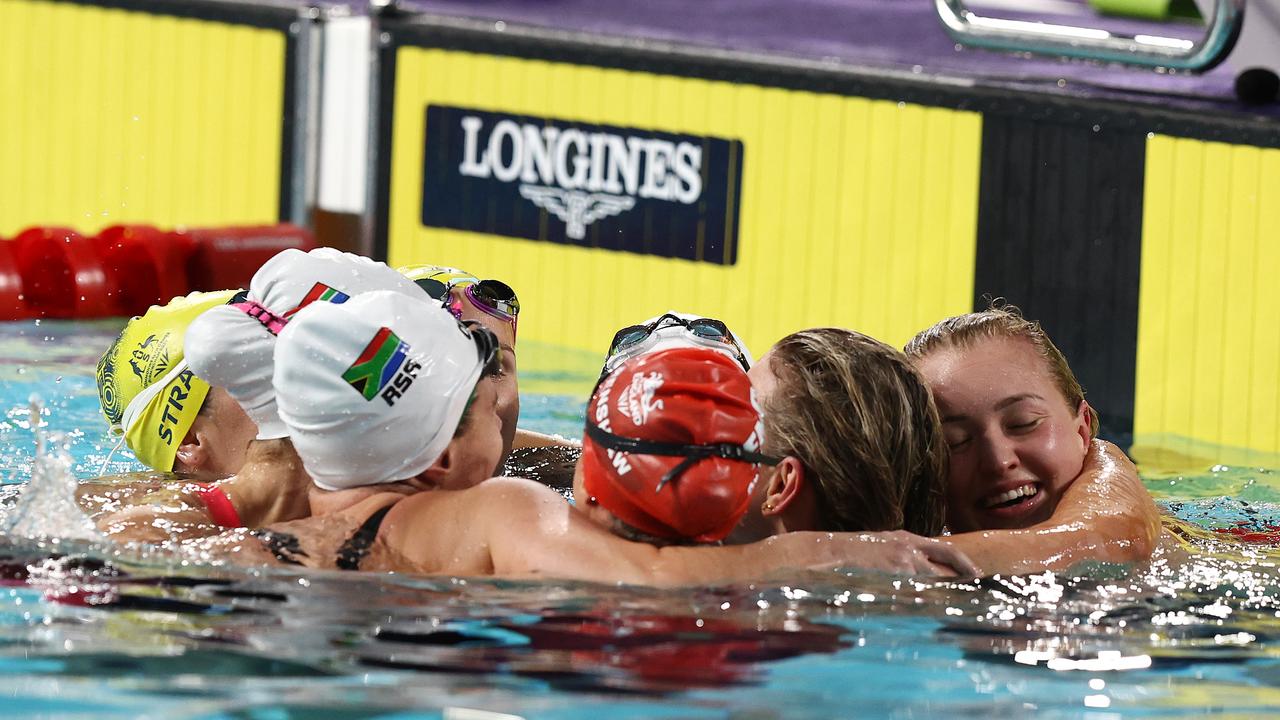 The Australian women’s breaststrokers have a group hug after their race.. Picture: Michael Klein