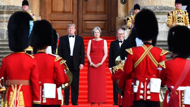 US President Donald Trump, Britain's Prime Minister Theresa May and her husband Philip May stand on steps in the Great Court ahead of a black-tie dinner with business leaders at Blenheim Palace. Photo: AFP