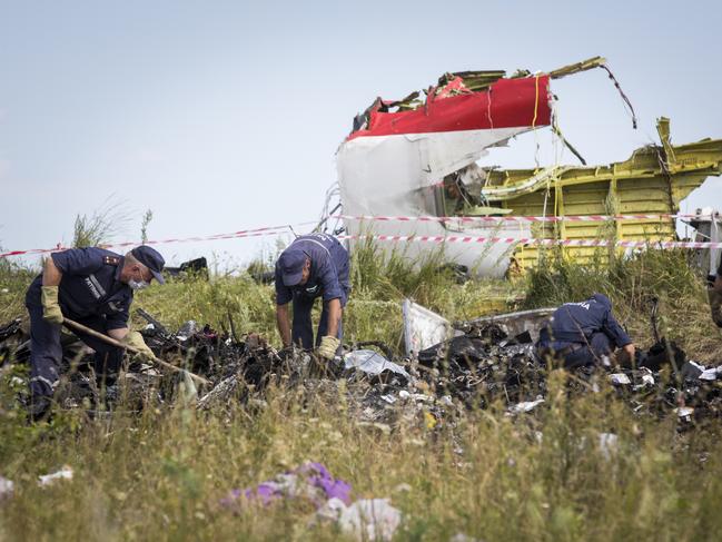 Ukrainian rescue servicemen look through the wreckage of Malaysia Airlines flight MH17. Picture: Getty