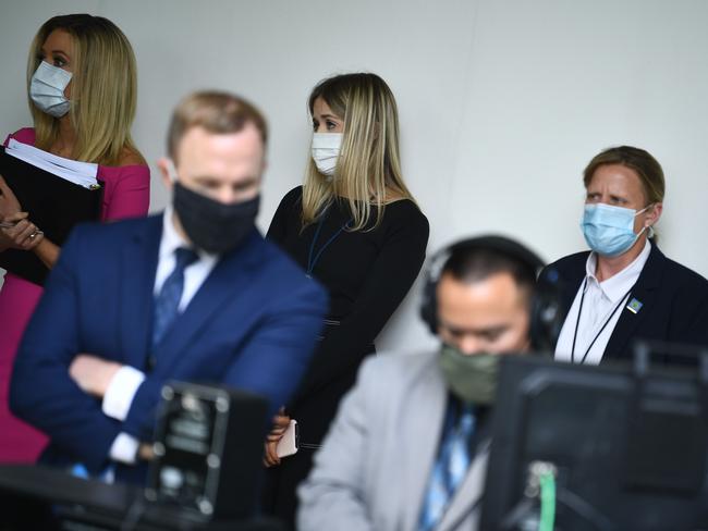 White House Press Secretary Kayleigh McEnany (L) looks on with other White House staff as US President Donald Trump speaks during a press conference. Picture: AFP