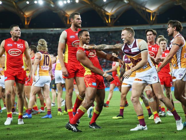 Touk Miller of the Suns clashes with Mitch Robinson of the lions during the round 22 AFL match between the Gold Coast Suns and Brisbane Lions at Metricon Stadium on August 18, 2018 in Gold Coast, Australia. Picture: Jason O'Brien, Getty Images.