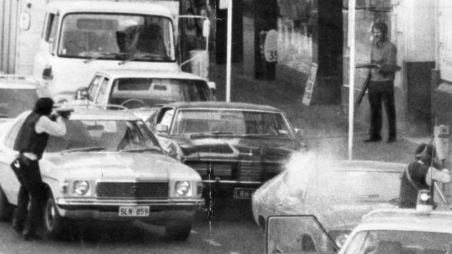 Hambly-Clark gun shop siege in Rundle Street, Adelaide, 11 May 1976. This pic of the dramatic scene in Rundle Street was taken by reader Mr J. A. Shaw, of Clarence Park, seconds before a police sniper fired on the gunman (Michael Leo O'Connor, pictured at right). The flare in the foreground is a tear gas canister bursting against a parked car.