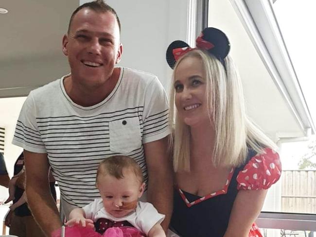 Skylah with dad Peter Austin and mum Hollee on her first birthday. Peter was exposed to coronavirus on a flight to Qld.