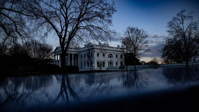 The sun sets over the White House on Monday after Democrats and Republicans agreed on a $US900bn COVID-19 relief package. Picture: AFP