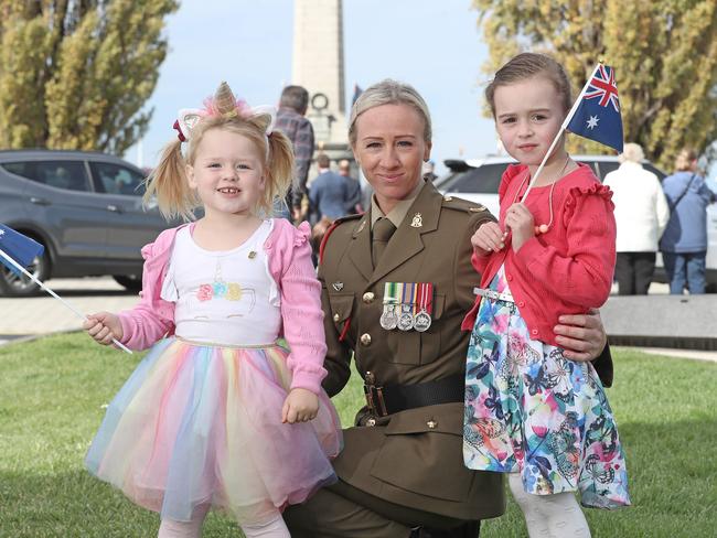 Shelley Cuthbert with her two daughters Scarlett, 3, and Sienna, 5, at the Anzac Day march and service in Hobart. Picture: LUKE BOWDEN