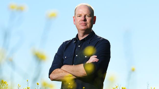 Tom Gleeson poses for a photograph in a Canola Field near Romsey, Friday, October 19, 2018. Tom Gleeson has started a petition to stop a mining exploration application near Romsey. (AAP Image/James Ross) NO ARCHIVING