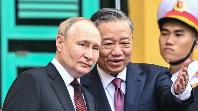 Vladimir Putin with Vietnam's President To Lam at the presidential palace in Hanoi on Thursday. Picture: AFP