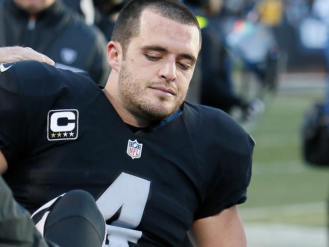 OAKLAND, CA - DECEMBER 24: Derek Carr #4 of the Oakland Raiders is attended to by medical staff after injuring his right leg during their NFL game against the Indianapolis Colts at Oakland Alameda Coliseum on December 24, 2016 in Oakland, California. Brian Bahr/Getty Images/AFP == FOR NEWSPAPERS, INTERNET, TELCOS & TELEVISION USE ONLY ==