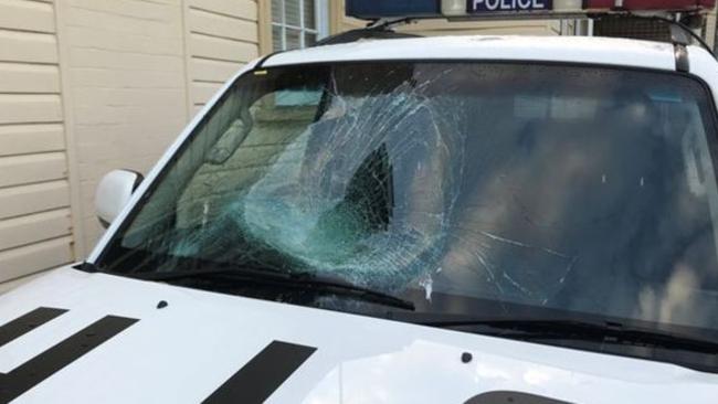 A naked man smashed his head through the front window of this police car at Byron Bay.