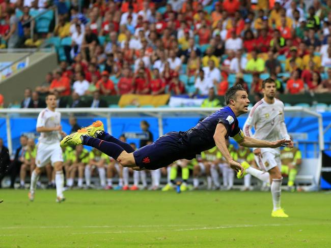 Netherlands' Robin van Persie flies through the air after scoring a goal during the Group B World Cup match between Spain and the Netherlands at the Arena Ponte Nova in Salvador, Brazil.