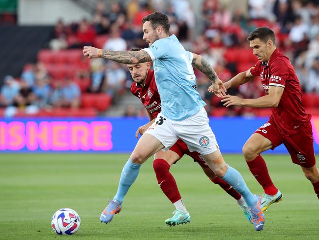 Melbourne City’s Aiden O'Neill battles Adelaide United pair Zach Clough and Isaias (right). Picture: Sarah Reed/Getty Images