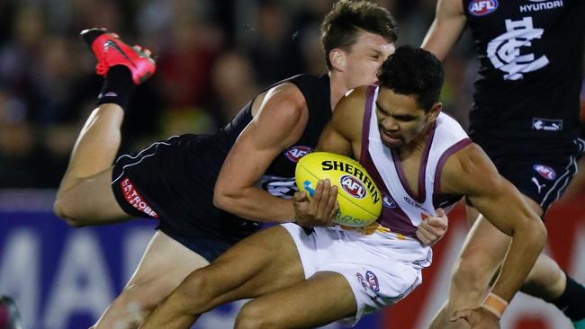 Sam Walsh lays a huge tackle on Charlie Cameron. Picture: Getty Images