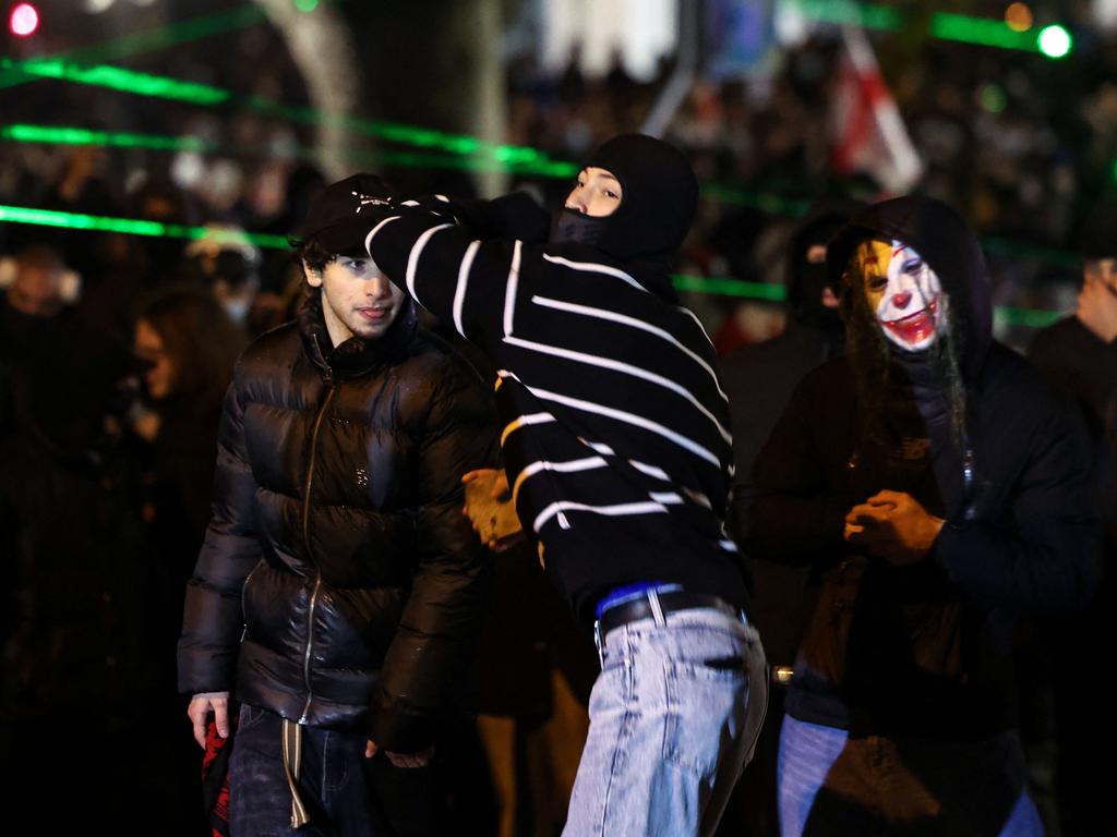 Protesters clash with police forces during the fifth straight night of demonstrations against the government's postponement of EU accession talks until 2028, in central Tbilisi on December 2, 2024. (Photo by Giorgi ARJEVANIDZE / AFP)