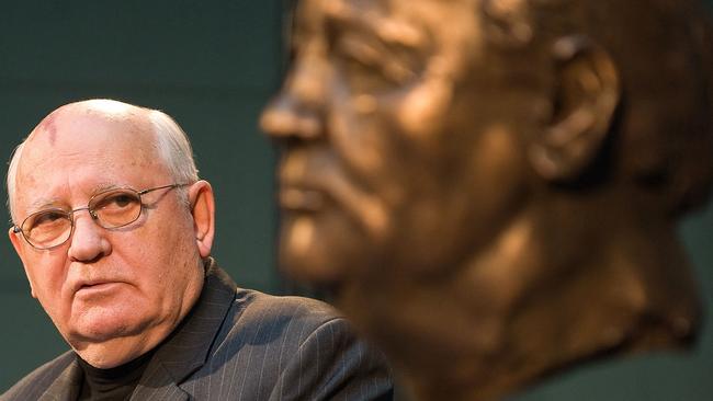 Mikhail Gorbachev looks at a bust of himself by French artist Serge Mangin after unveiling it to guests in Berlin, in 2009. Picture: AFP.