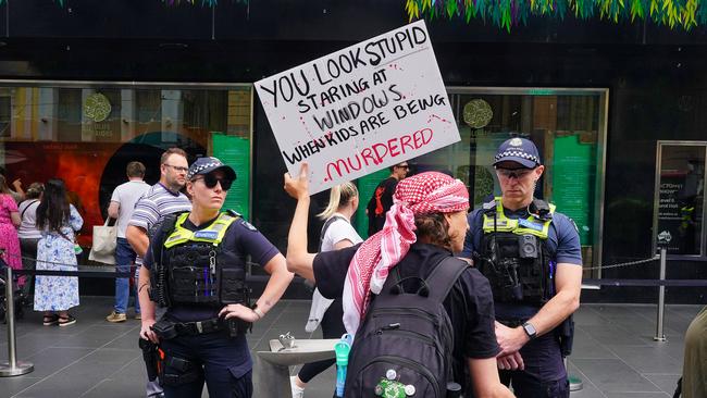 Pro-Palestinian protesters are seen along Bourke St Mall as Myer unveils its Christmas windows display. Picture: NewsWire/Luis Enrique Ascui