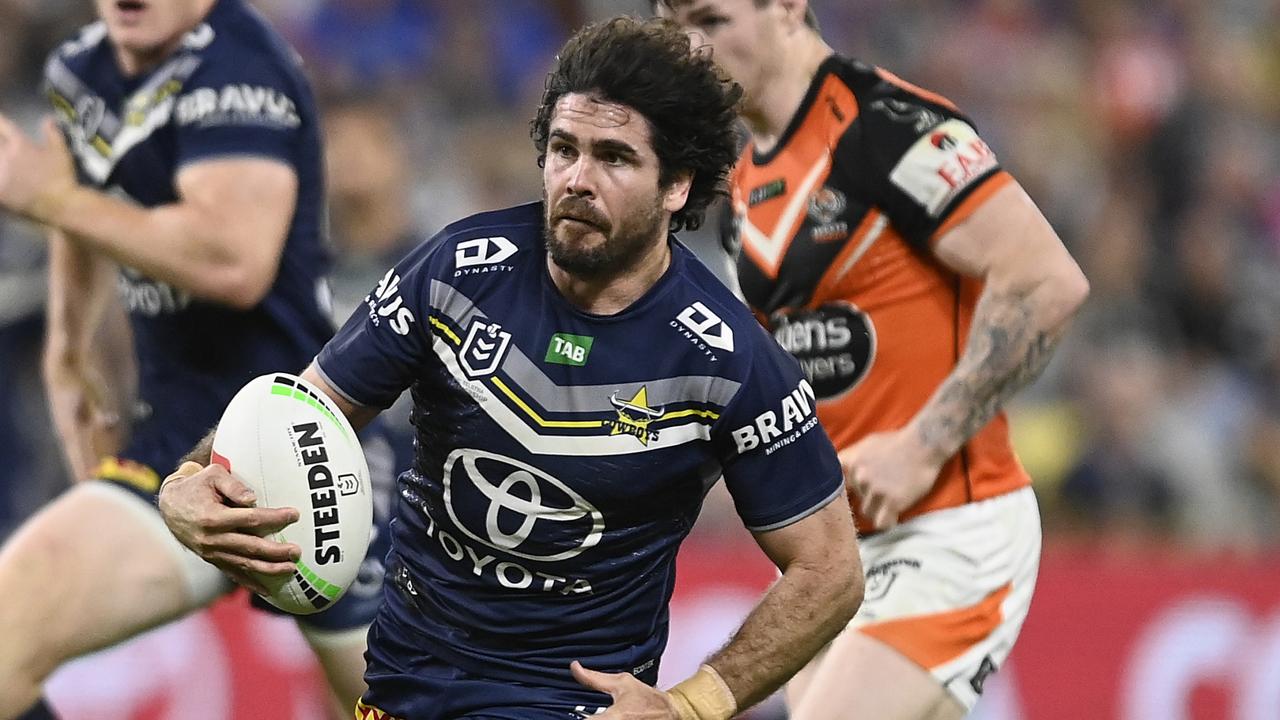 TOWNSVILLE, AUSTRALIA - JULY 01: Jake Granville of the Cowboys makes a break during the round 18 NRL match between North Queensland Cowboys and Wests Tigers at Qld Country Bank Stadium on July 01, 2023 in Townsville, Australia. (Photo by Ian Hitchcock/Getty Images)