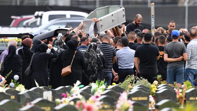 Mourners lift an empty coffin above their heads during the burial of Mahmoud ‘Mick’ Hawi at Rookwood Cemetery in February. Picture: AAP