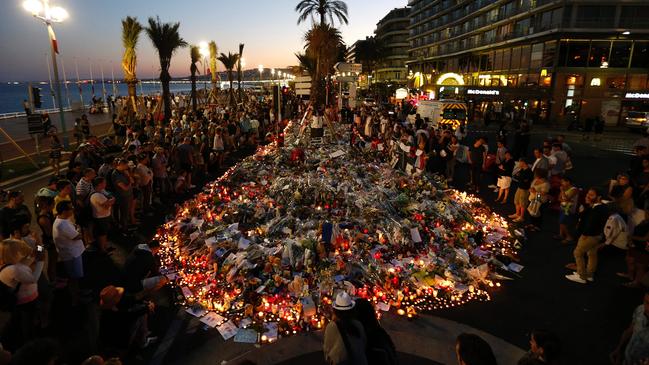 People gather at a makeshift memorial on the Promenade des Anglais in Nice on July 17, 2016, in tribute to the victims of the Bastille Day attack that left 84 dead. Picture: Valery Hache/AFP Photo