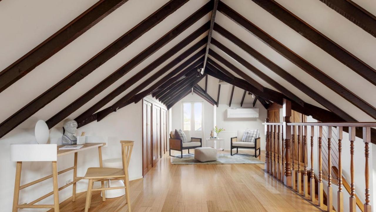 Soaring cathedral-style ceilings and arched timber trusses add drama to the home’s rear extension.