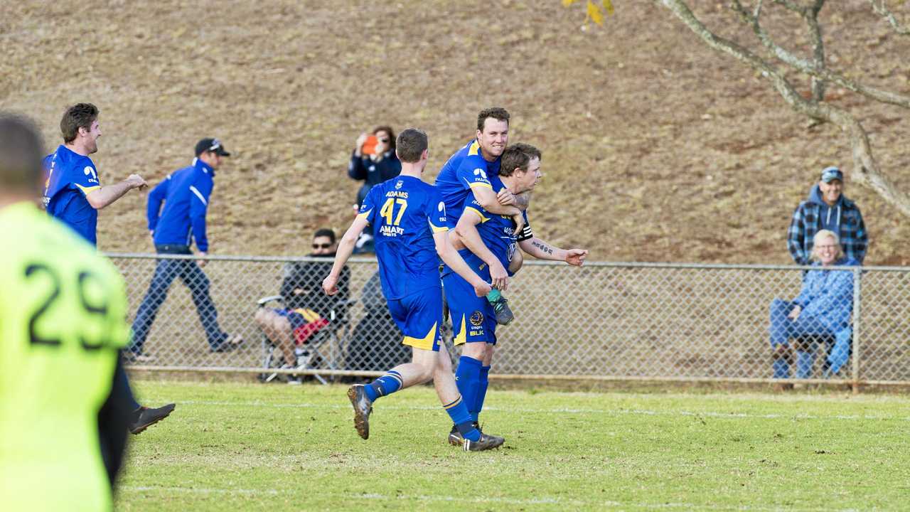 USQ players including Ashley Freier (top) and Brendan Willmot celebrate a goal against Willowburn. Picture: Kevin Farmer