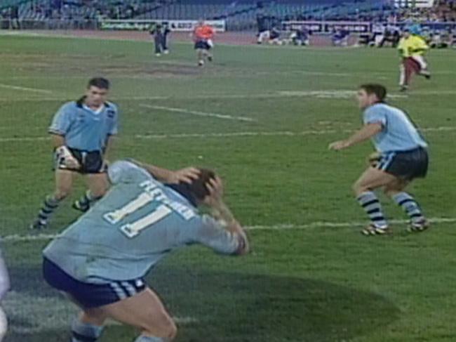 TV Frame Grab COURTESY CHANNEL NINE of NSW player Bryan Fletcher (no 11) try celebration by throwing the football hand grenade style at his teammates who fall to the ground during Queensland vs NSW State of Origin Game Three at Stadium Australia on 07 Jun 2000.