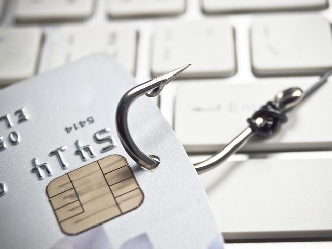 phishing - fish hook with a credit card on white computer keyboard credit card fraud generic, scammers, theft