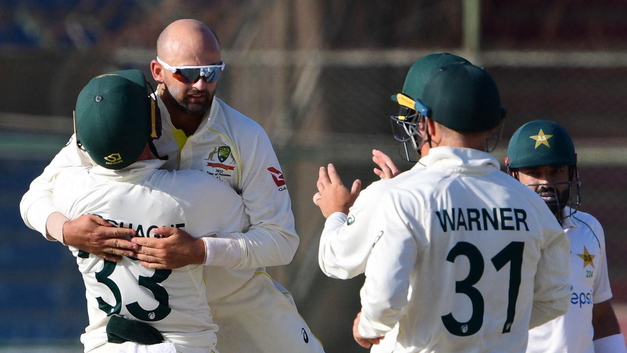 Australia's Nathan Lyon celebrates with teammates at the National Cricket Stadium in Karachi. (Photo by ASIF HASSAN / AFP)