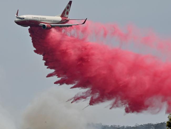 A Rural NSW Fire Service plane drops fire retardant on bushfire near Taree on November 12. Picture: Peter Parks/AFP