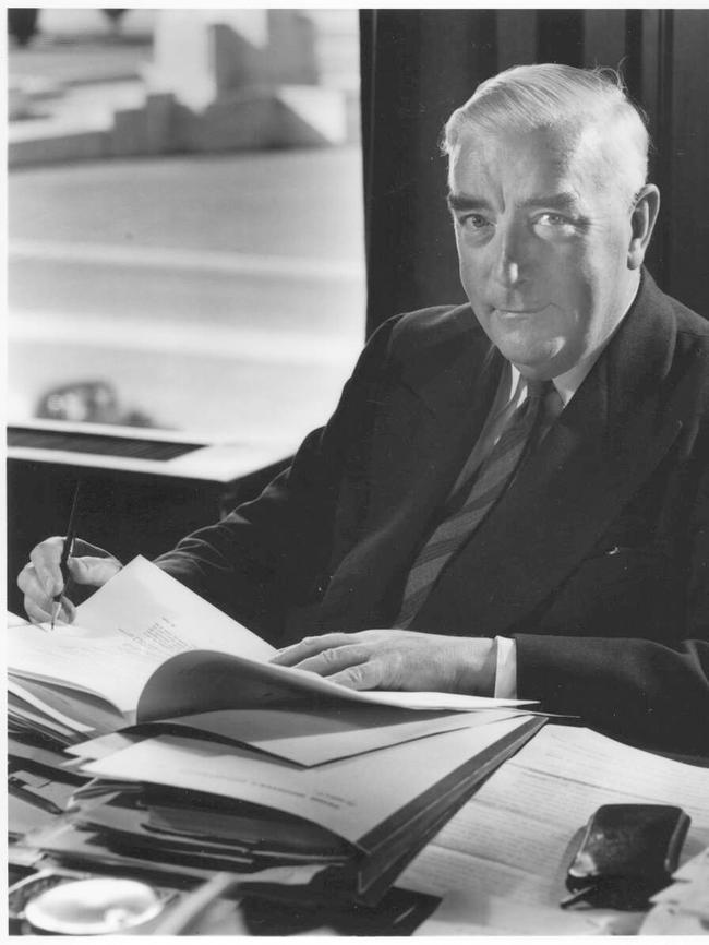 Sir Robert Menzies sitting at his desk signing papers at Parliament House in Canberra, circa 1950. Picture: National Library of Australia