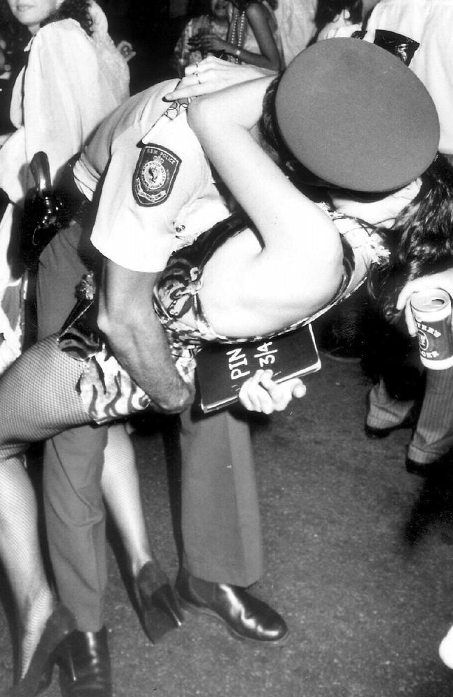 Picture of a police officer and a woman kissing on New Years Eve 1986. Photo: Courier Mail archives