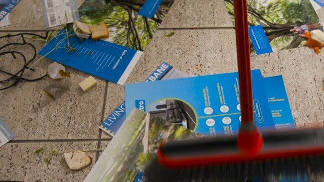 The ad shows Mr Condren sweeping away council newsletters, champagne glasses and Christmas lights. Picture: ALP.