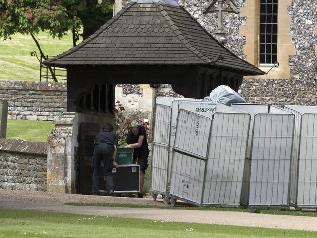 Staff deliver more equipment to the 12th century church. Picture: Splash News