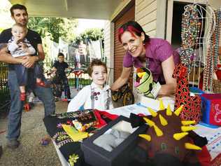 Mother-of-six Bec Draper shows off her fair trade handicrafts to Ezra (front), 3, and husband Brendan with Isaac, 1, and Noah, 9. Mrs Draper has been nominated for The AusMumpreneur Awards. Picture: David Nielsen