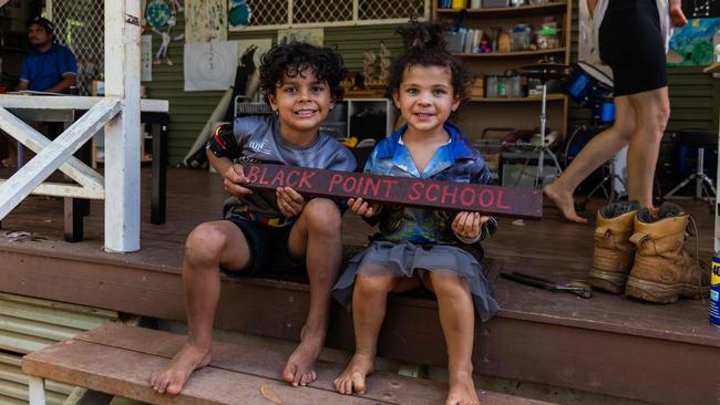 Lui Cooper (7) and Shiloh Cooper (4) with the sign that used to hang in their school. Picture: Helen Orr