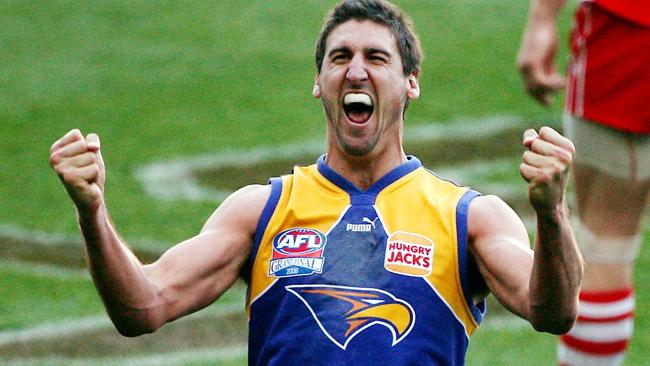 2006 Grand Final. Sydney Swans v West Coast Eagles. MCG. Dean Cox celebrates the siren sounding as Brett Kirk sits on the ground.