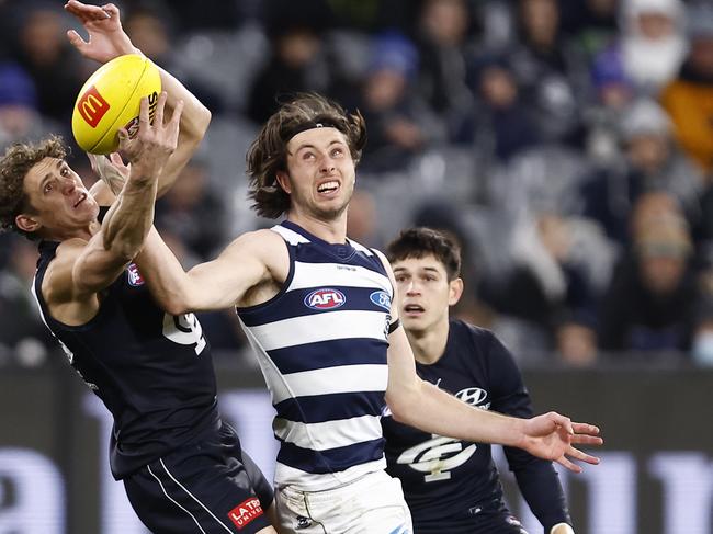 Jack Henry gets a hand in to stop Charlie Curnow. Picture: Darrian Traynor/Getty Images