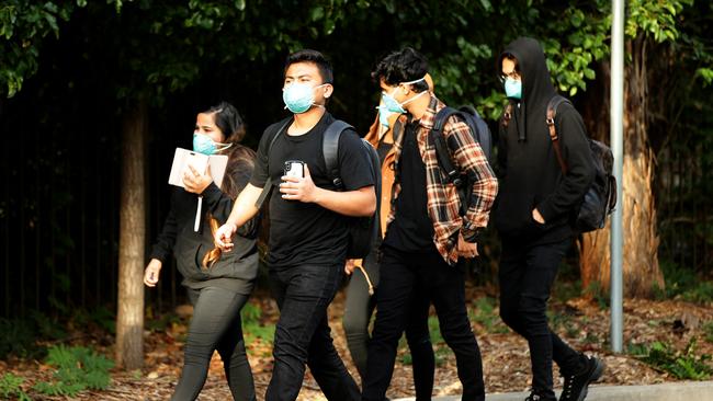 Staff members leaving the Anglicare Newmarch House in Caddens where a cluster of COVID-19 cases has broken out. Picture: Jonathan Ng