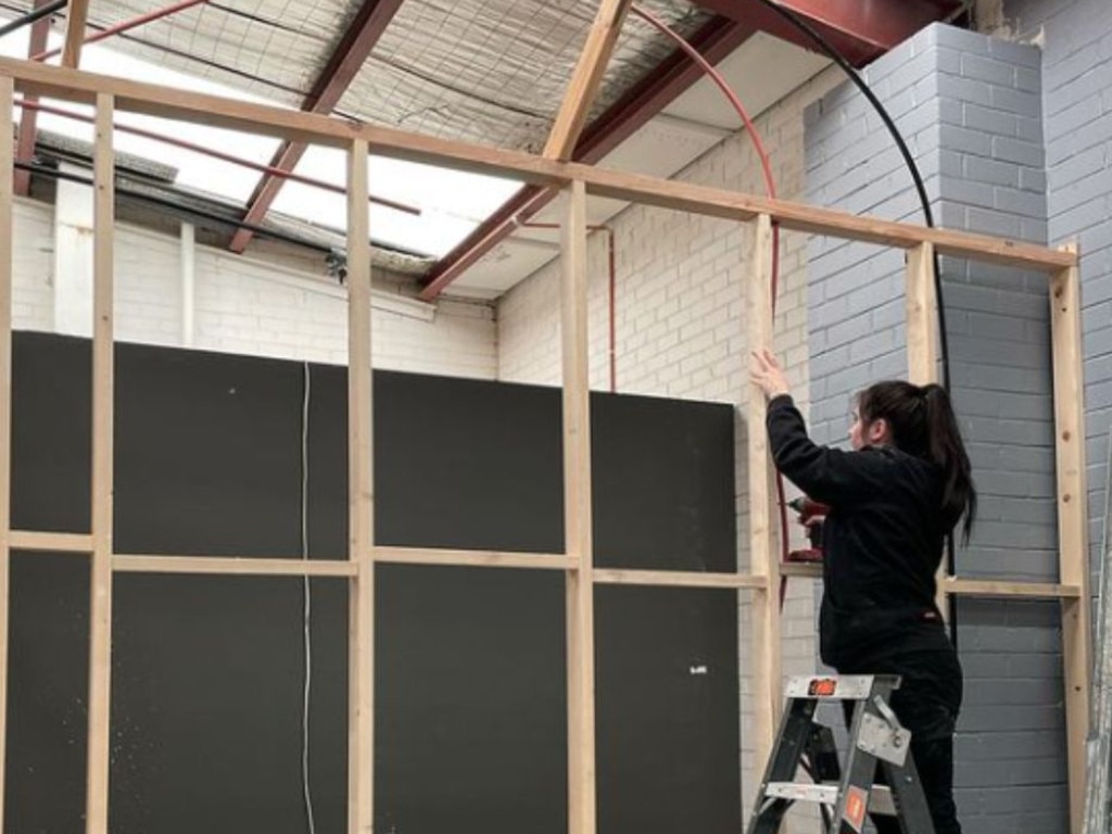 Lara Smyth working in a distillery as an apprentice plumber. Picture: Supplied.