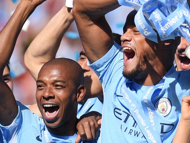 LEICESTER, ENGLAND - MAY 05: Vincent Kompany of Manchester City lifts the Premier League Trophy alongside David Silva, Nicolas Otamendi and Fernandinho as Manchester City celebrate winning the Premier League Title during the Premier League match between Leicester City and West Ham United at The King Power Stadium on May 5, 2018 in Leicester, England.  (Photo by Laurence Griffiths/Getty Images)