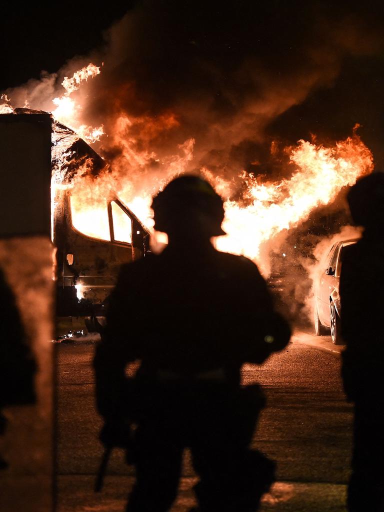 French anti riot police officers watch a truck burn in Nantes. Picture: Sebastien Salom-Gomis / AFP