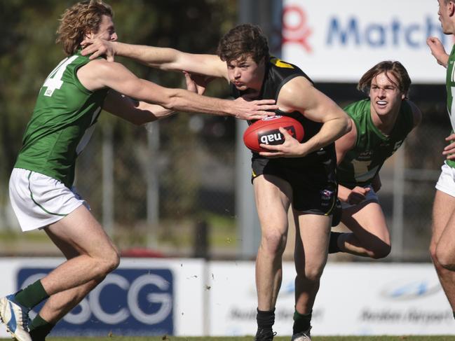 Country’s Mason DeWit attempts to tackle City’s Joel Cusack during yesterday’s Young Guns match. Picture: Getty Images