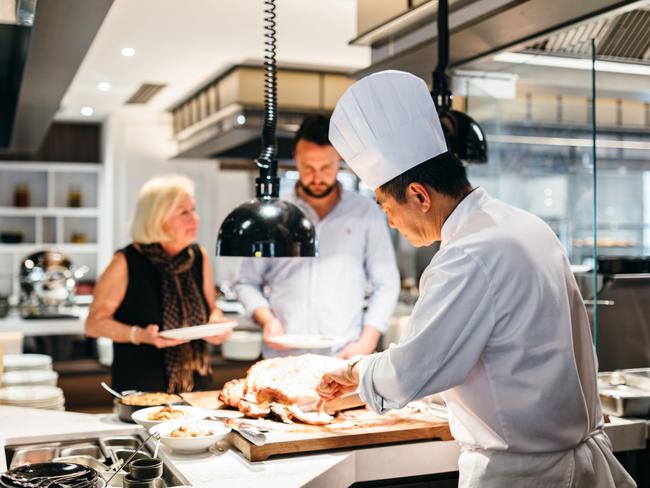 Each cuisine station is manned by a chef who will cook dishes to order at the new fine-dining smorgasbord.