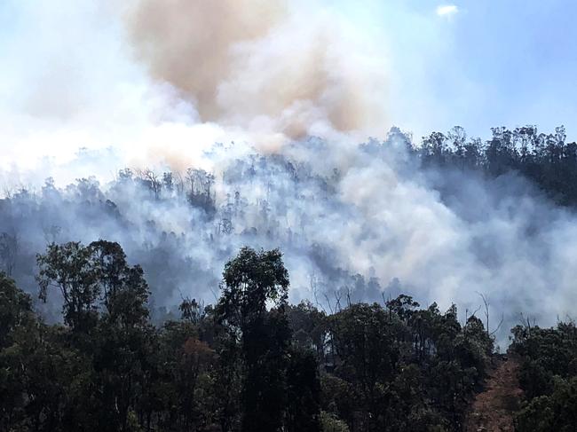 Ian McDonald and Kathleen Ellrott of the Nerimbera Rural Fire Service keep an eye out on the blazes above North Rockhampton