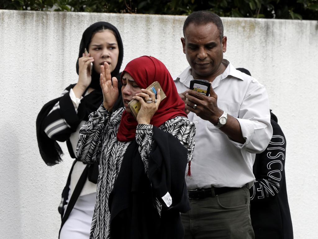 People wait outside a mosque in central Christchurch, New Zealand, Friday, March 15, 2019. (AP Photo/Mark Baker)