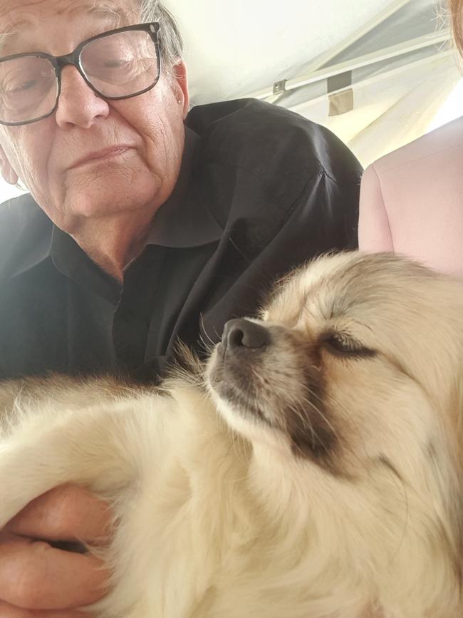 Gary Tucker is reunited with Misha, the Tibetan spaniel, after the dog was lost in the outback for five months. Picture: Supplied